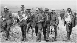 The &quot;War to End All Wars,&quot; like all the wars that have followed it, discarded human lives on all sides. Here, a German prisoner helps British wounded make their way to a dressing station. Image:  Imperial War Museum